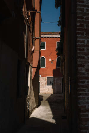 Venice, Italy - August 13, 2016: Narrow and bright streets of sunny Venice, Italy.のeditorial素材