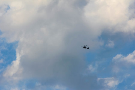 Overcast gray sky with dense clouds and small aircraft visible in atmospheric conditionsの写真素材