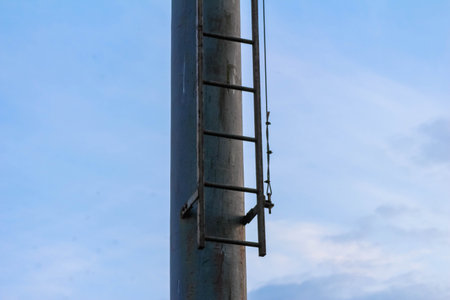 Modern urban skyline with steel construction frame against cloudy blue sky creating industrial architectural perspectiveの写真素材