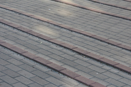 Weathered wooden boardwalk planks with metal strips creating linear pattern and rustic textureの写真素材
