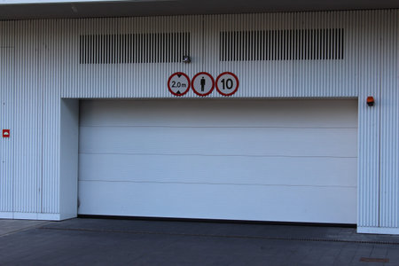 Modern commercial building entrance with metal security shutters and architectural details in urban...