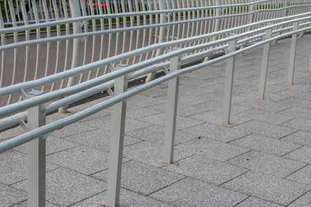 Close-up view of metal mesh safety railing system on modern pedestrian bridge infrastructure