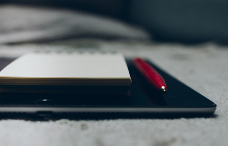 MOSCOW, RUSSIA- JUNE 10, 2017: Apple iPad, pen and notebook on plaid.のeditorial素材