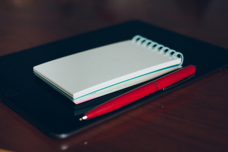 MOSCOW, RUSSIA- JUNE 10, 2017: Apple iPad, pen and notebook on wooden desk.のeditorial素材