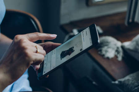 Moscow, RUSSIA - August 20th, 2017: Young woman holding smartphone with search page screen of Instagram application. Instagram is largest and most popular photograph social networking.のeditorial素材