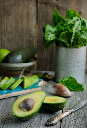 Fresh green avocado on old wooden backgroundの写真素材