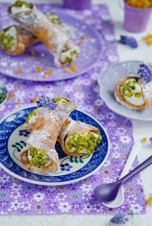 Italian Cannoli with green pistachio nuts and candied orangeの写真素材