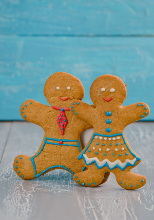 Gingerbread family on the white wooden backgroundの写真素材