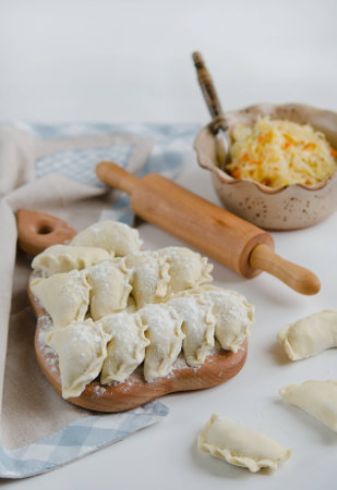 Raw Dumplings with cabbage (Varenyky) on a wooden boardの写真素材