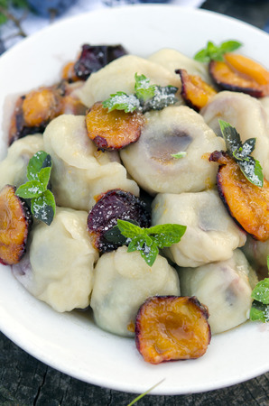 Delicious sweet dumplings stuffed with fresh plumsの写真素材