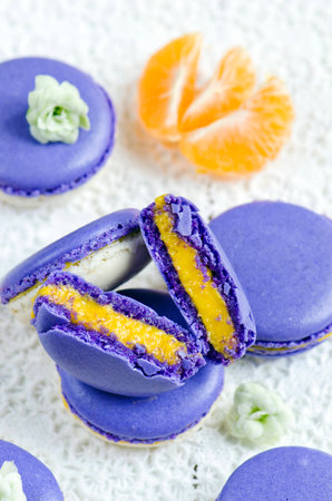 Colored makarons with tangerine ganache on white backgroundの写真素材