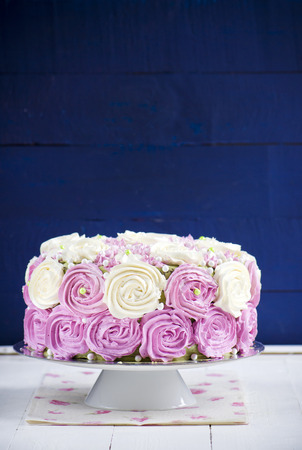 Sponge cake with cream cheese on a wood backgroundの写真素材