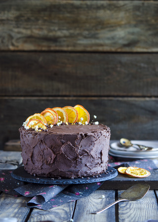 Extra chocolate cake on a dark beer with orangesの写真素材