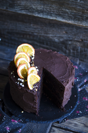 Extra chocolate cake on a dark beer with orangesの写真素材