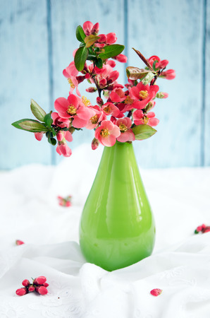 Bouquet of spring blossom in vase on wooden tableの写真素材