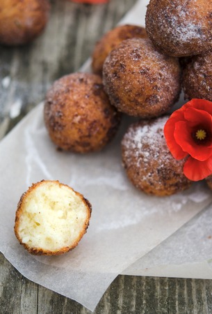 Freshly baked cheese donuts with powdered sugarの写真素材