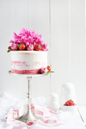 Strawberry cake with floral decoration on a white backgroundの写真素材
