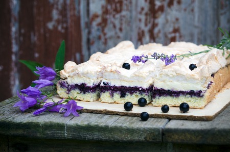 Sponge cake with blueberries on an old wooden tableの写真素材