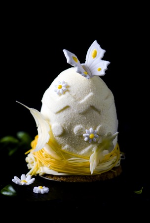 Easter egg.Elegance french mousse cake with velour coating as decoration on blackl background. Modern european cake.の写真素材