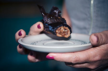 Chocolate choux pastry, chocolate crumble, creme caramel with black chocolate, chantilly with beans thin, extra-black glaze and crunchy chocolate flakesの写真素材