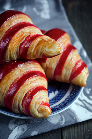 Raspberry croissant on a dark wooden backgroundの写真素材