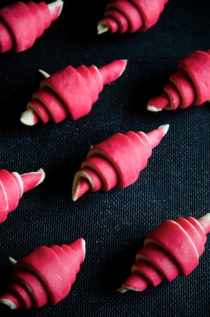 Raspberry croissant on a dark wooden backgroundの写真素材