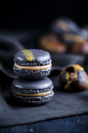 Black macaron with chesnut ganache and caramelの写真素材