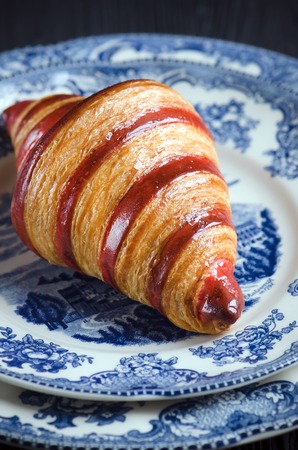 Raspberry croissant on a dark wooden backgroundの写真素材