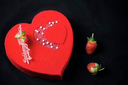 Cake with strawberry mousse under a red chocolate velor coverの写真素材