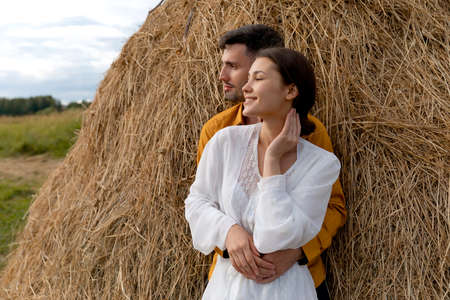 Couple in love on a haystack in the field. High quality photoの写真素材