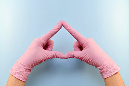 A triangle, an arrow, a window, a figure constructed from the hands in pink rubber medical gloves on...