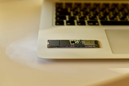 The SSD drive chip in the lower right corner of the laptop. Small parts of the chip. In the soft...