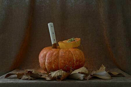 Sang notched pumpkin with a knife on a velvet background.の写真素材