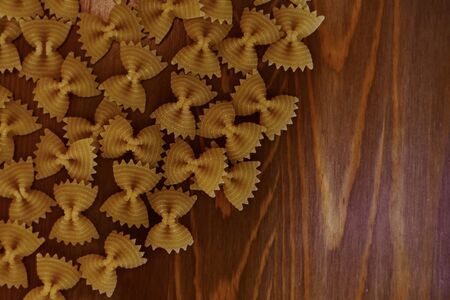 Butterfly-shaped paste in the corner, large, on a wooden background.の写真素材