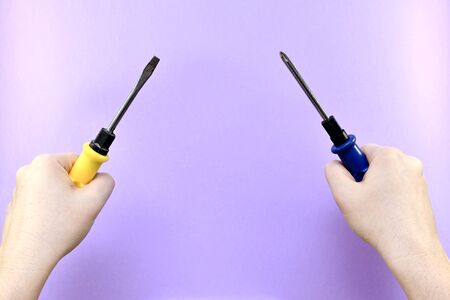 Two hands with a screwdriver in each, ready to go.の写真素材