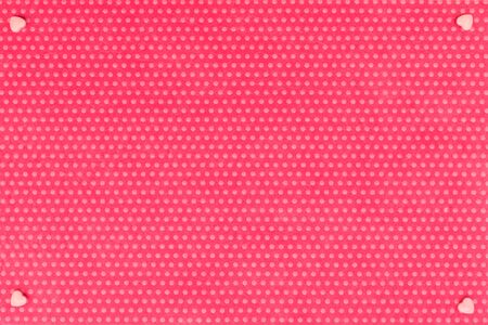 Pink Pink hearts in the corners on the textile background, fuchsia with a print in white polka dots. View from above. hearts in the corners on the textile background, fuchsia with a print in white polka dots. View from above.の写真素材