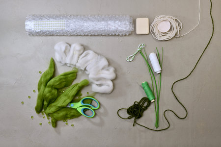 Workplace, flat lay, with materials and tools, prepared to work with natural wool to make the...