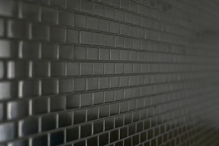 Metal rectangles lined with mosaic brickwork.の写真素材