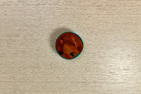 A small ruddy Easter cake in the shape of blue silicone. In the center of an empty light table.