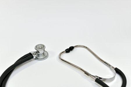 Acoustic head with binaural tubes and headband on the left and ear tips on the right medical...