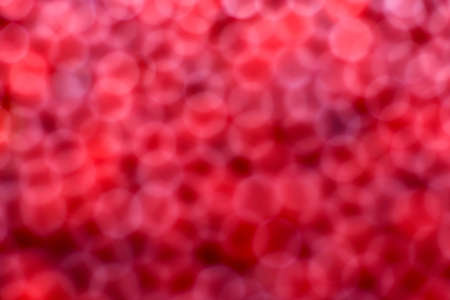 The background is red, defocused, one dimensional. Bokeh looks like blood cells, flat bodies, erythrocytes.の写真素材