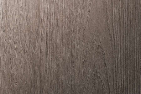 Grey is a brown wooden background with beige veins. Medium dark textured longitudinal cut.の写真素材