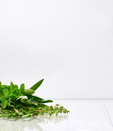 Spicy herbs partly bouquet on a white surface with reflection.の写真素材