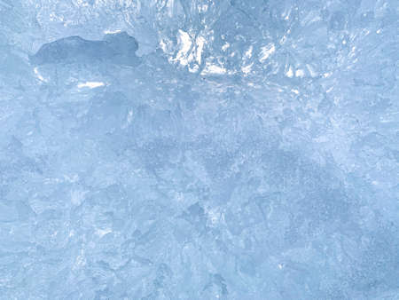 An abstract relatively uniform background with blue streaks and transparent ice crystals in a single slice fragment.の写真素材