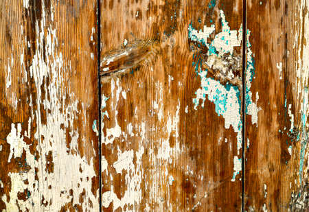 The background is wooden knotty from old boards with peeling erased paint white turquoise.の写真素材