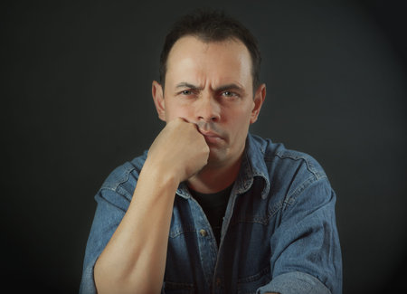 Portrait of the sad man against a dark background