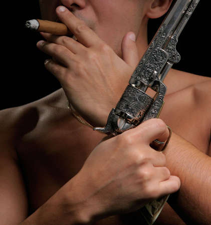 Young man with pistol in handの写真素材