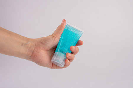 Male hand using hand skin sanitizer gel tube for washing hand. Close-up