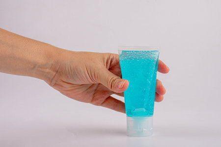 Male hand using hand skin sanitizer gel tube for washing hand. Close-up