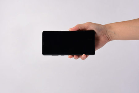 Hand and smartphone isolated on white background.